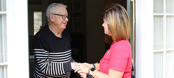 homecare staff checking in with elderly man at his home